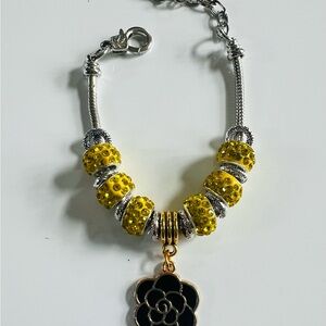 Elegant Silver and Yellow Beaded Bracelet with Black Flower Charm